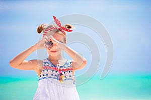 Little girl at beach during caribbean vacation. Portrait of beautiful kid background blue sky