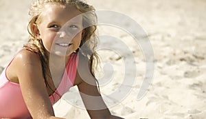 Little girl on the beach in the sand