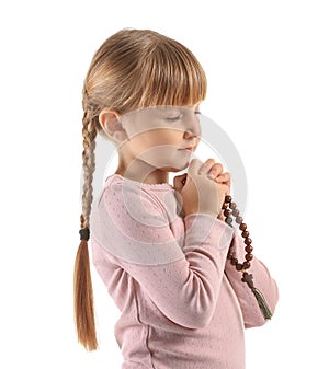 Little girl with beads praying on white background