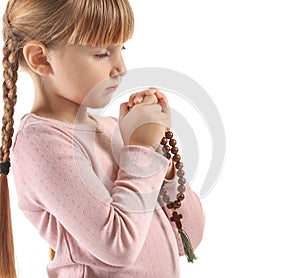 Little girl with beads praying on white background