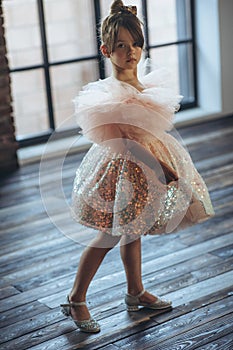 Little girl in a beautiful dress. Happy fashionable child.