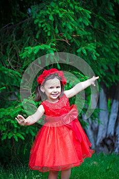 A little girl in a beautiful red dress. Portre is a sweet girl
