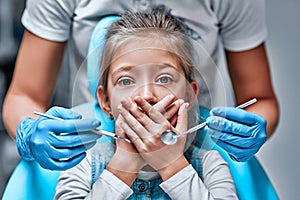 Little girl is being scared at the dentist