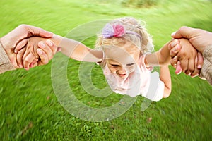 Little girl being spun in circles at park