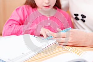 Little girl being taught writing and reading