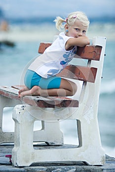 Little girl on a bench