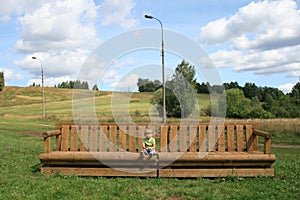 Little girl on a big bench