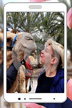 Little girl, big camel, smiling friends fun. Mobile photo.