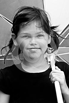 Little girl with big colorful umbrella