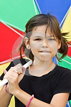 Little girl with big colorful umbrella