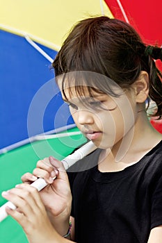 Little girl with big colorful umbrella