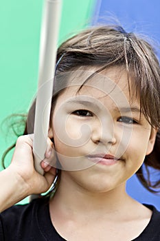 Little girl with big colorful umbrella