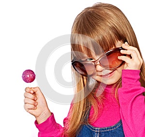 Little girl in big dark glasses and lollipop