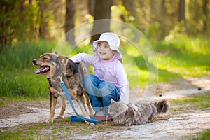 Little girl with big dog and cat