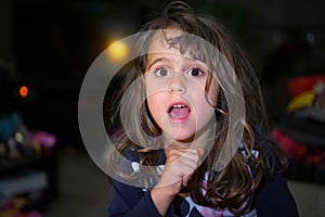 little girl with big eyes make funny faces, with copy space