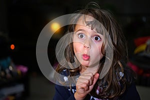 little girl with big eyes make funny faces, with copy space