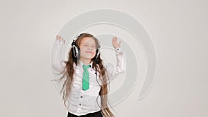 Little girl in big headphones.