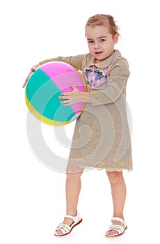 Little girl with big inflatable ball