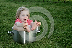 Little girl in big pan