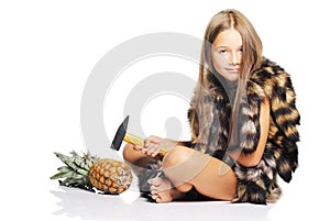 Little girl with big pineapple and hammer