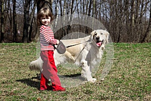 Little girl with big retriever outdoors