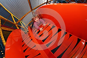 Little girl on a big slide