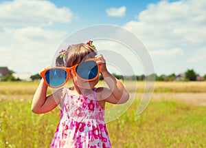 Little girl with big sunglasses