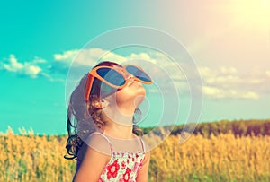 Little girl with big sunglasses