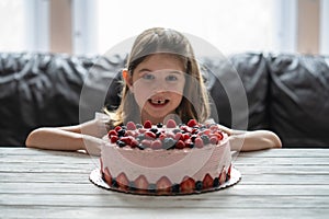 Little girl birthday cake.Home made cake with berries. Cake with Strawberry, blackberry, blueberry, and raspberry on a