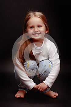 Little girl on a black background