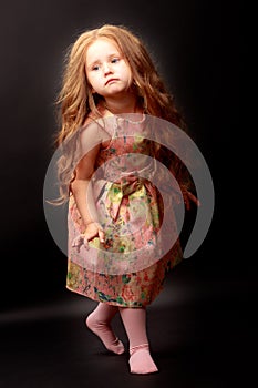 Little girl on a black background