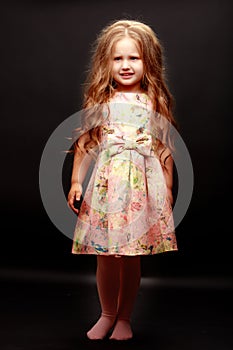 Little girl on a black background