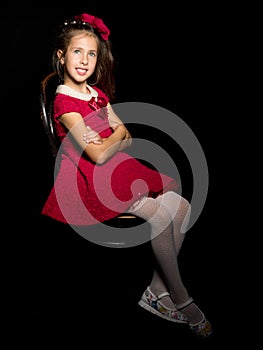 Little girl on a black background