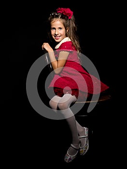 Little girl on a black background