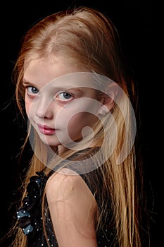 Little girl on a black background