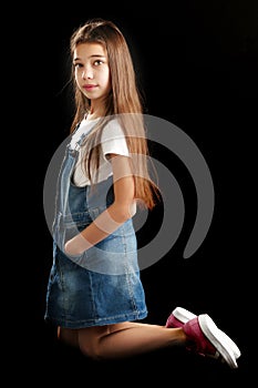 Little girl on a black background