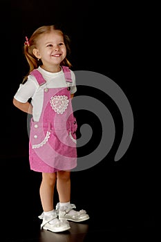 Little girl on a black background