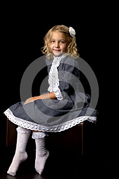 Little girl on a black background.style and fashion.