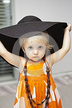 little girl in black hat