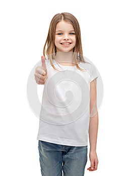 Little girl in blank white tshirt showing thumbsup