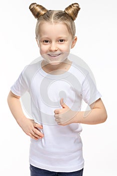 Little girl with blond hair smiling and showing a hand like, in a white T-shirt on a white background