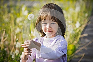 Little girl and blow ball