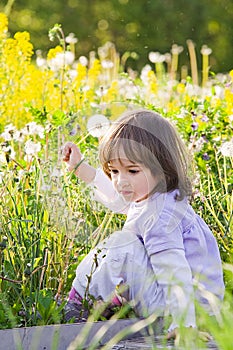 Little girl and blow balls