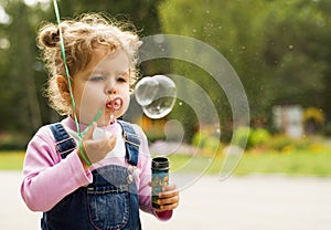 Little girl blow bubbles