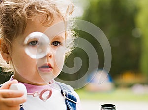 Little girl blow bubbles