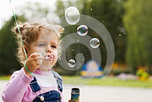 Little girl blow bubbles