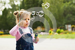 Little girl blow bubbles