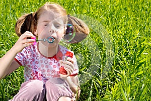 Little girl blowing bubbles