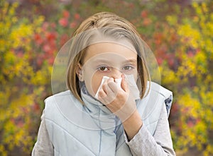 Little girl blowing her nose