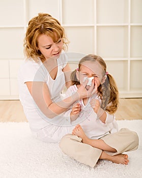 Little girl blowing nose